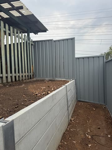 Concrete sleeper wall meeting a Colorbond fence