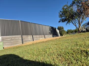 Colorbond fence built on top of a concrete sleeper retaining wall