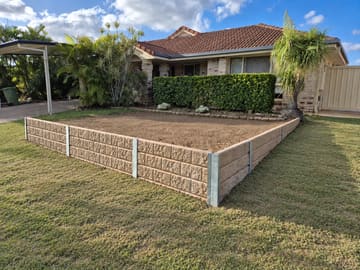 Sandstone-look concrete sleeper retaining wall at a home in Ormeau