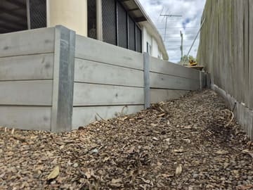 Retaining wall running along the side of a house