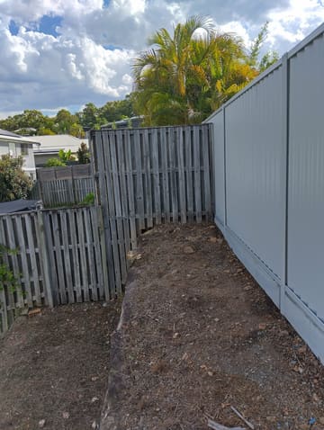Colorbond fence with sleepers along a side path
