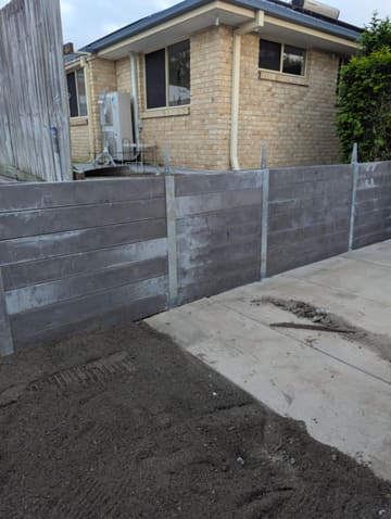 Concrete sleeper retaining wall behind a house