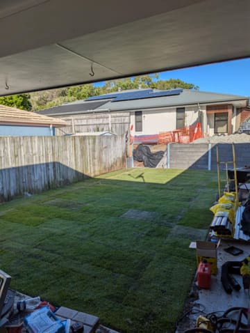 Levelled backyard with new turf after the wall was built